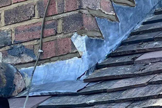 Applying lead flashing to pitched roof by Jacobs Roofing Services Ltd  Ruislip